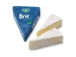 KI generiert: Das Bild zeigt ein Stück Blauschimmelkäse. Der Käse hat eine helle Farbe mit blauen Adern.