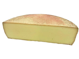 KI generiert: Ein halber Laib Käse mit einer bräunlichen Rinde und gelblichem Inneren.