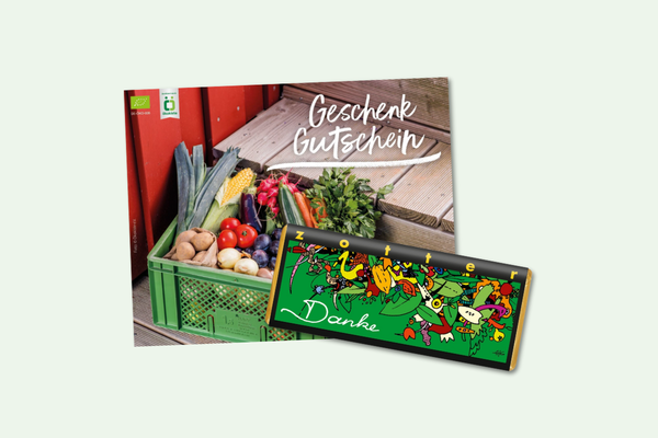 KI generiert: Ein Geschenkgutschein mit frischem Gemüse und einer "Danke"-Schokolade. Text: "Geschenk Gutschein".