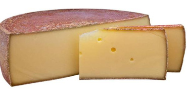 KI generiert: Das Bild zeigt ein großes Käsestück mit einem herausgeschnittenen Teil, wodurch die gelbliche Innenstruktur sichtbar wird. Der Hauptinhalt des Bildes ist der Käse.