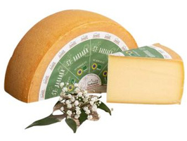 KI generiert: Ein halbes Laib Käse mit einem Stück abgeschnitten, daneben Blumen. Auf dem Etikett: „St. Jakob St. Baraka”.