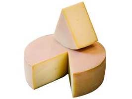 KI generiert: Ein runder Laib Käse mit einem herausgeschnittenen Stück.