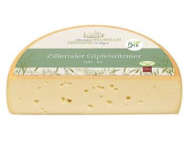 KI generiert: Halber Laib Käse mit Etikett auf der Oberseite. Text: "Zillertaler Gipfelstürmer".