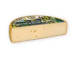 KI generiert: Das Bild zeigt ein Stück Blauschimmelkäse. Der Käse hat eine helle Farbe mit blauen Adern.