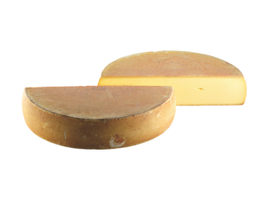 KI generiert: Zwei runde Käselaibe, einer halbiert, der andere in Viertel. Kein Text vorhanden.