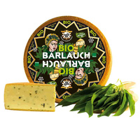 KI generiert: Ein ganzer und ein angeschnittener Laib Bio-Bärlauch-Käse mit frischen Bärlauchblättern. Text: "BIO BÄRLAUCH".